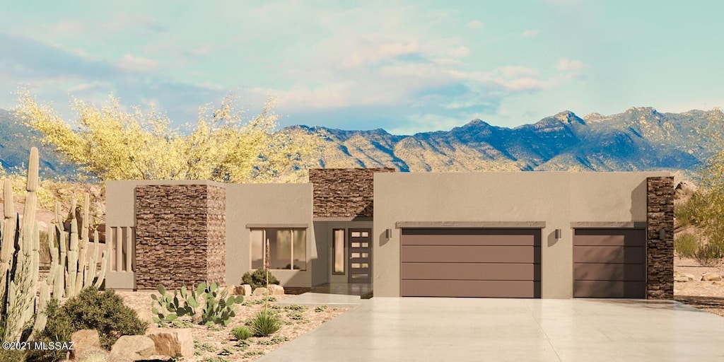 pueblo-style house with a mountain view and a garage