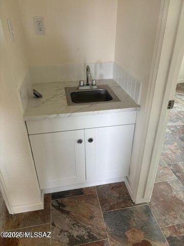 bathroom with vanity and stone finish flooring