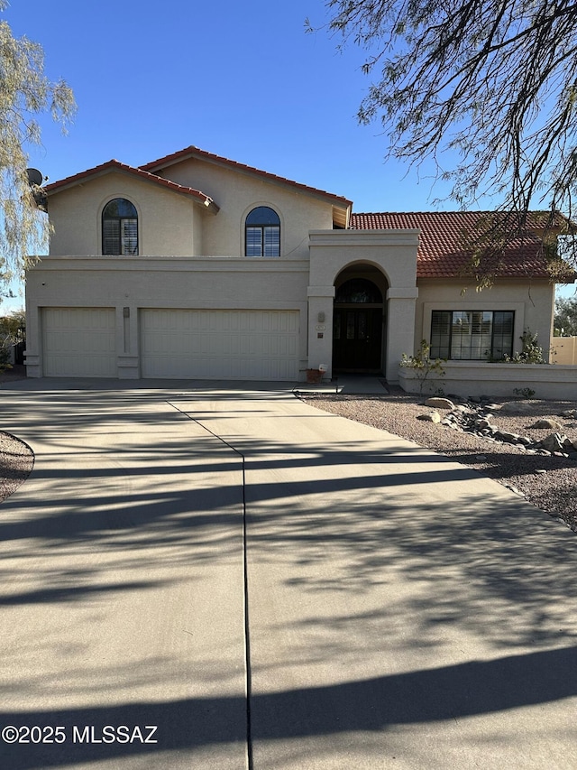 mediterranean / spanish-style house with a garage