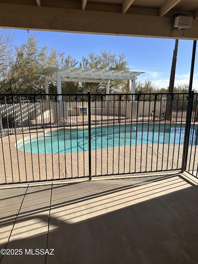 view of swimming pool with a patio and a pergola