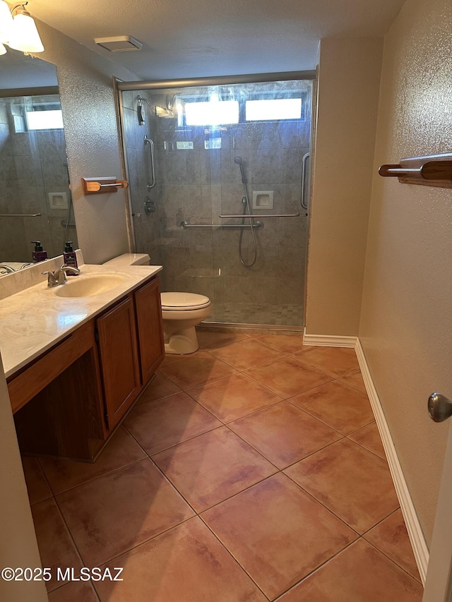 bathroom with walk in shower, vanity, and tile patterned flooring