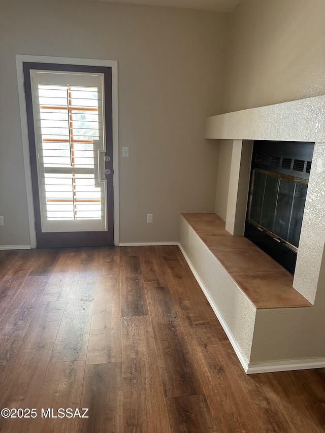 unfurnished living room featuring dark wood-type flooring