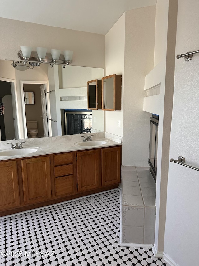 bathroom featuring toilet, vanity, and tile patterned flooring