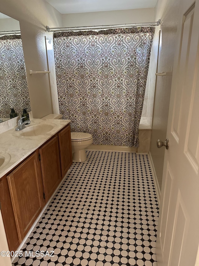 full bathroom featuring tile patterned floors, toilet, vanity, and shower / tub combo