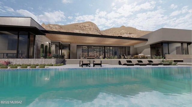 view of pool with a mountain view and a patio