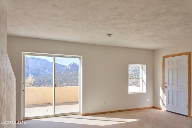 spare room featuring a mountain view