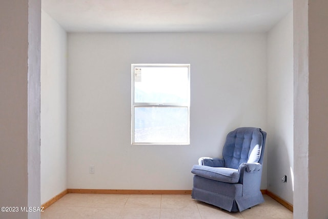 living area featuring a wealth of natural light and light tile flooring