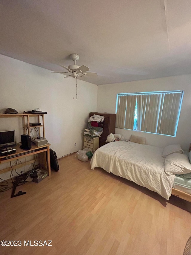 bedroom with ceiling fan and light hardwood / wood-style floors