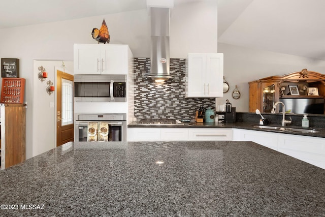 kitchen with sink, white cabinets, dark stone countertops, stainless steel appliances, and wall chimney exhaust hood