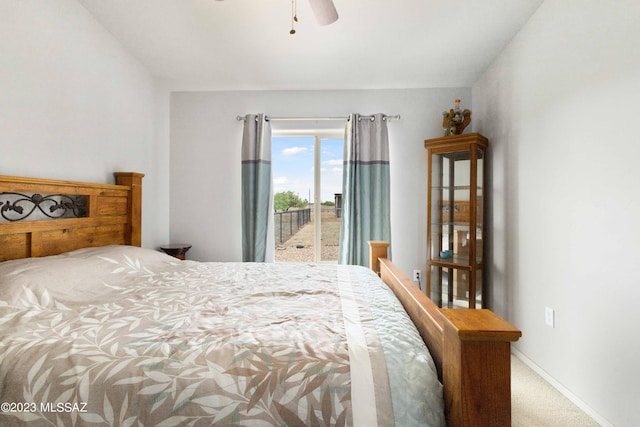 carpeted bedroom featuring ceiling fan and access to exterior