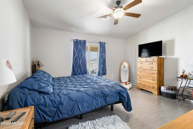 bedroom featuring ceiling fan, dark hardwood / wood-style floors, and vaulted ceiling