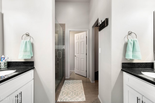 bathroom featuring a shower with door, vanity, and wood-type flooring