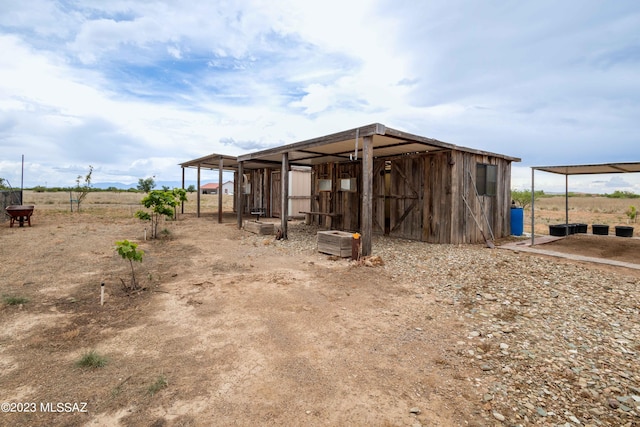 view of shed / structure featuring a rural view