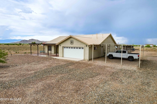 view of front of home with a mountain view and a garage