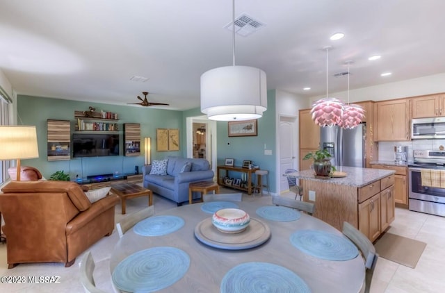 tiled dining space featuring ceiling fan