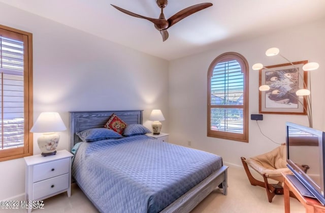 bedroom featuring light colored carpet and ceiling fan