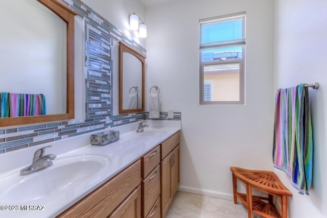 bathroom featuring tile floors, backsplash, dual sinks, and vanity with extensive cabinet space