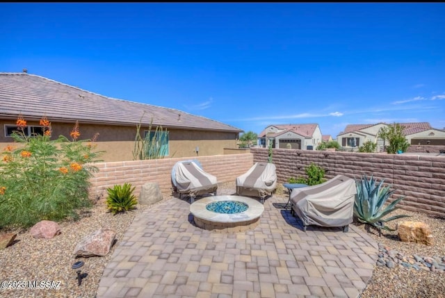 view of patio with an outdoor fire pit