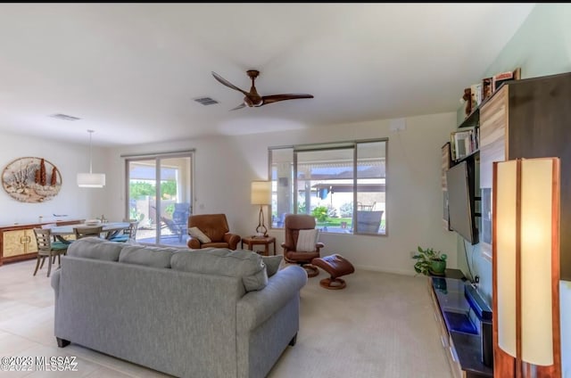 tiled living room with ceiling fan