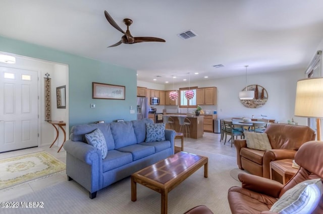 tiled living room with ceiling fan