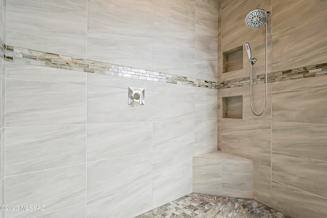 bathroom featuring a tile shower