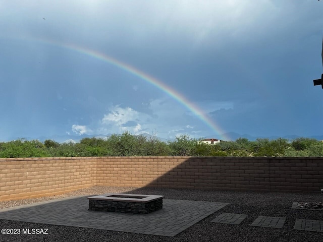 view of terrace with an outdoor fire pit