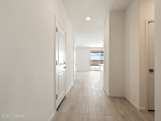 hall with light hardwood / wood-style floors