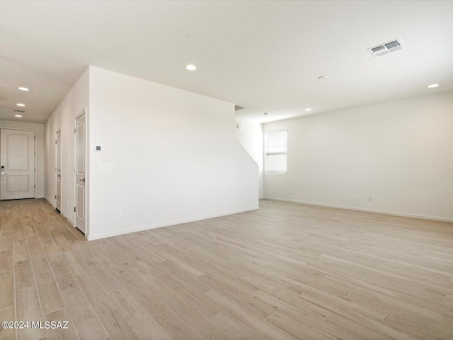 unfurnished room with light hardwood / wood-style floors