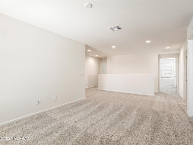 unfurnished room featuring light colored carpet