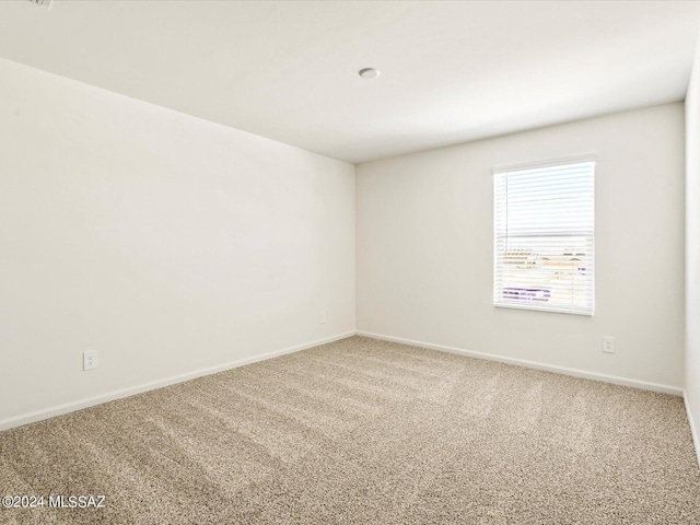 unfurnished room featuring carpet