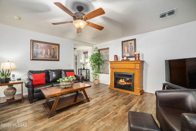 living room with ceiling fan and wood-type flooring