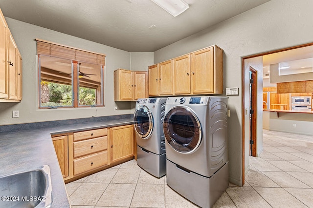 laundry room featuring cabinets, independent washer and dryer, sink, ceiling fan, and light tile floors