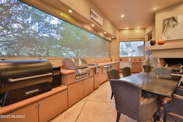 view of terrace featuring sink, a grill, and an outdoor kitchen