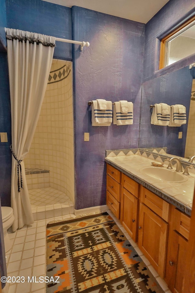 bathroom with walk in shower, tile flooring, toilet, and vanity