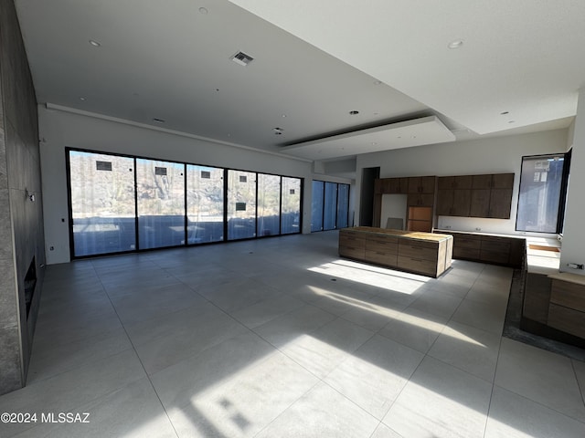 unfurnished living room with light tile patterned floors