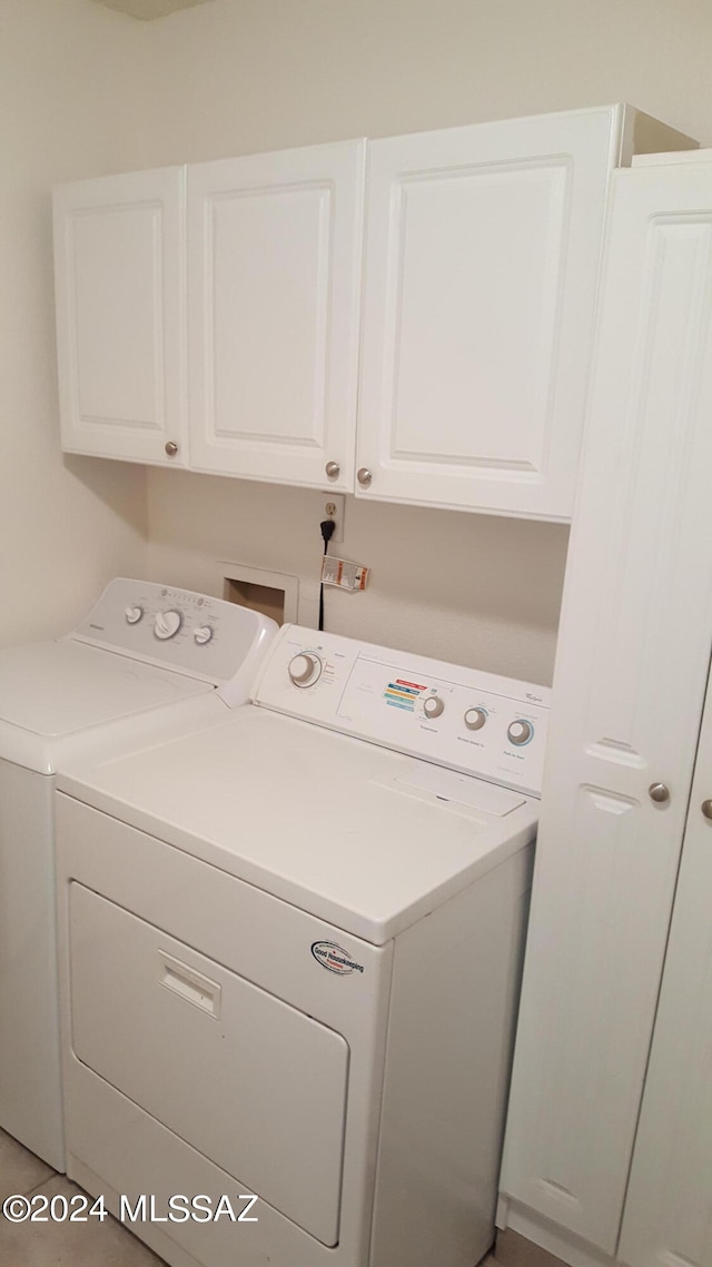 laundry area with independent washer and dryer, washer hookup, and cabinets