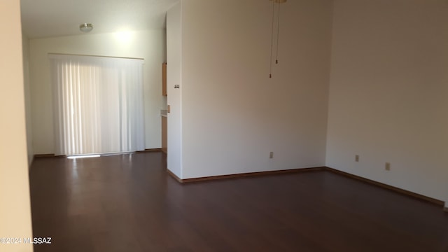 empty room featuring hardwood / wood-style flooring and lofted ceiling