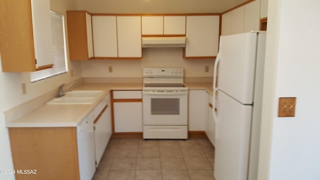 kitchen featuring white appliances, sink, light tile floors, and wall chimney exhaust hood