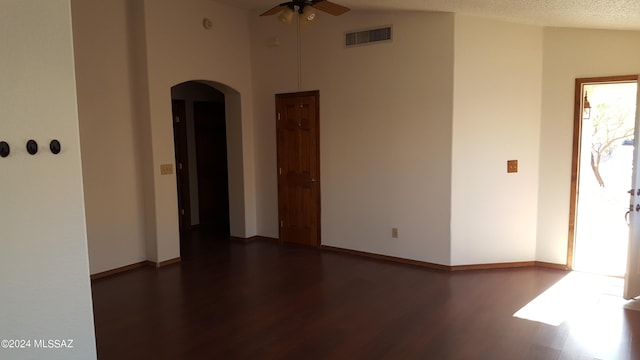 unfurnished room featuring high vaulted ceiling, a textured ceiling, ceiling fan, and dark hardwood / wood-style floors