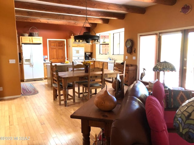 living room featuring beam ceiling and light hardwood / wood-style flooring