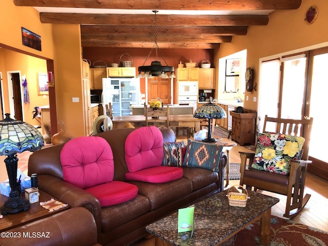 living room featuring beamed ceiling and light hardwood / wood-style flooring