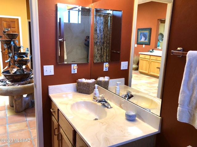 bathroom with tile patterned flooring, vanity, and a shower with curtain