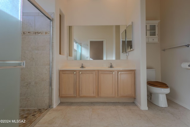 bathroom with an enclosed shower, vanity, and toilet