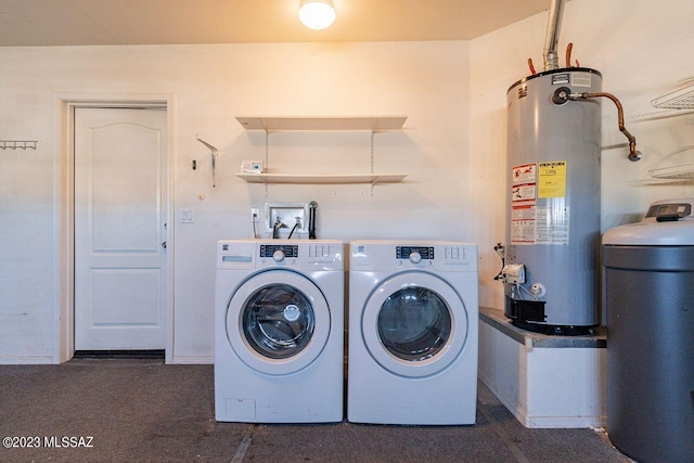 clothes washing area with washer and dryer and water heater