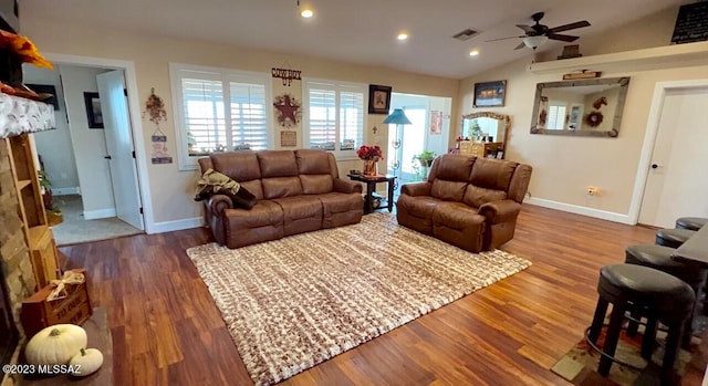 living room with wood-type flooring, lofted ceiling, and ceiling fan