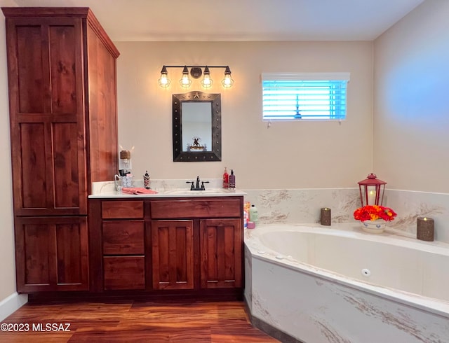 bathroom featuring vanity, hardwood / wood-style floors, and a washtub