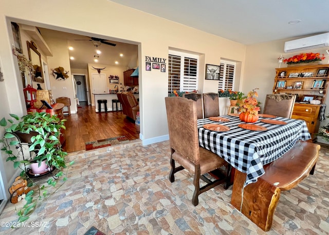 dining area with light hardwood / wood-style flooring, ceiling fan, and a wall mounted AC