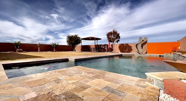 view of swimming pool with a patio and a water slide