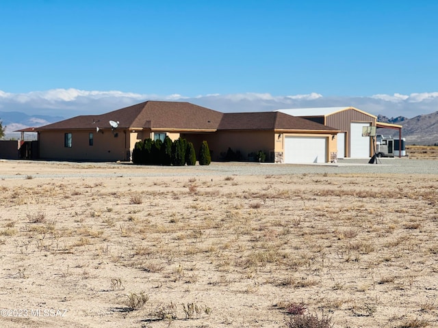 view of front of house with a mountain view and a garage