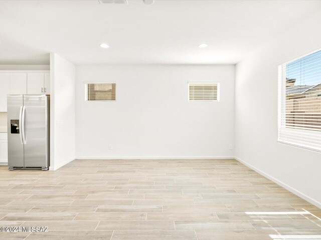 spare room with visible vents, recessed lighting, baseboards, and wood finish floors